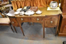 An Edwardian mahogany breakfront sideboard with curtained rail over single central drawer, flanked