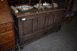 A George III oak four panel mule chest of traditional arrangement, with moulded top over four