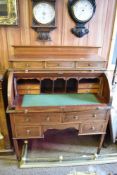 An Edwardian banded mahogany cylinder bureau, the raised superstructure with three short drawers