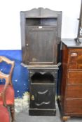 An Edwardian stained wood bedside cabinet sold together with a 20th century stained oak corner