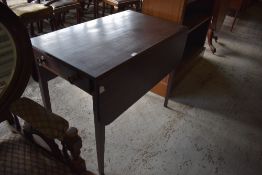 An early 19th century mahogany Pembroke table, the rounded oblong flaps with reeded edge detail over