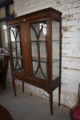 An Edwardian inlaid mahogany display cabinet, having ribbon and swag inlaid frieze, over pendant
