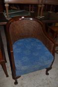 A 1920s cane backed mahogany tub form armchair. Seat height 33CM.