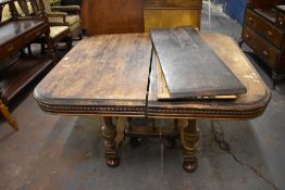 Victorian morgani extending dining table, of rounded square form with carved edge detail over the