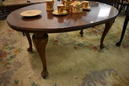 A 1920s mahogany oval extending dining table, lacking winder, sold with one short leaf. 75CM. X
