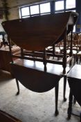 An early 20th century oak dropleaf gateleg table sold together with an early 20th century mahogany