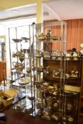 Three modern chromed metal and glass display shelves, two large and one small corner.