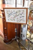 A 19th century Mahogany pole screen, the embroidered screen raised on mahogany stem, with fluted and