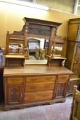 An Edwardian mahogany mirror back sideboard of traditional arrangement, decorated with foliate