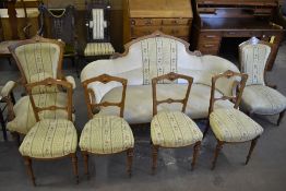 A Victorian inlaid Mahogany seven piece salon suite, comprising settee, his and hers easy chairs and
