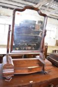 A Victorian figured mahogany swing dressing mirror with central lift up section. 91CM.