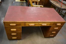 An early 20th century oak pedestal desk, the drawers with integral handles 76CM. X 152CM.