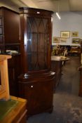 A reproduction mahogany glazed double corner cupboard. 179CM.