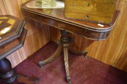 An early 19th century mahogany pedestal tea table the D shaped top with inlaid banding over a turned