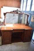 A Victorian mahogany mirror back sideboard, the large mirror plate with scroll carved cresting and