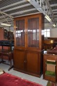 A 20th century glazed mahogany bookcase over cupboard, 215CM. X. 120CM.
