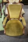 A Victorian walnut easy chair. with carved and inlaid decoration, part upholstered in green draylon,