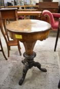 A Victorian figured walnut pedestal sewing table or workbox, of circular form, the tapering