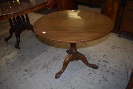 An Edwardian inlaid mahogany circular snap top stem table with turned column issuing three downswept