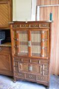 A modern Chinese elm cabinet, with an arrangement of drawers and glazed doors and cupboards,