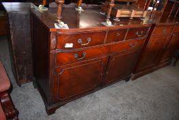 A Reproduction mahogany sideboard, of bow fronted form with long frieze drawer over further long