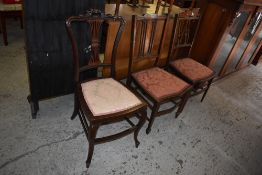 A group of three Edwardian mahogany bedroom chairs.