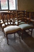 A group of four continental mahogany dining chairs with shaped moulded rails, serpentine fronted