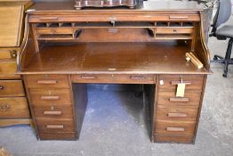 An early 20th century or roll top desk of larger than normal proportions 114 CM. X 150CM.