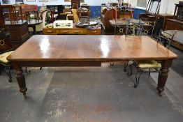 A Victorian mahogany extending dining table, of rectangular form with moulded edge detail and canted