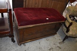 An early 20th century stained mahogany box seat the rectangular padded top with burgundy
