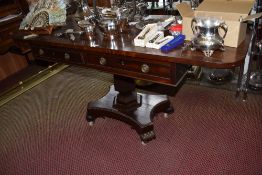 An early 19th century mahogany pedestal table, the rounded rectangular over two cockbeaded drawers