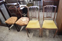 A pair of Victorian mahogany balloon back single chairs, with carved rails, serpentine seats and