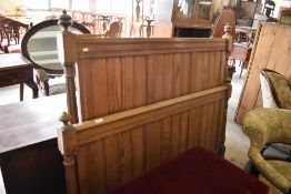 A pair of 19th century pine bed ends, having tongue and groove panels and incised rails between