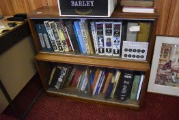 A mid century two tier glazed mahogany bookcase, 81cm x 89cm the glass slides containing various