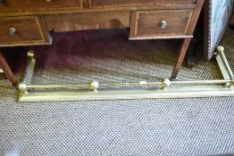 A brass fire fender, with ball and pole gallery and bead moulding 130CM.