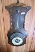 A 1940s oak barometer, damage to thermometer scale. 56CM.