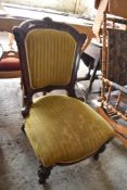 A Victorian mahogany framed easy chair with carved and moulded decoration. Seat 38CM.