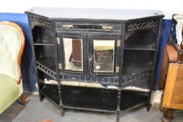 A Victorian ebonised wood salon cabinet base, of canted oblong form with mirrored cupboards to