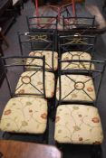 A set of six modern metal framed dining chairs the seats upholstered in patterned floral material.