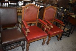 A pair of Victorian light oak armchairs upholstered in stained and studded leather, the arms with