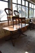 A Victorian inlaid walnut loo table(af) an early 20th century oak reclining armchair, a reproduction