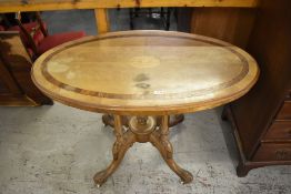 A Victorian oval satinwood table, with central inlaid conch shell paterae within quartered