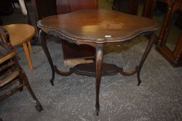 An Edwardian mahogany occasional table, of shaped outline with four slender cabriole style legs