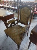 A late Victorian upholstered each chair, with stipple carved and arched crest-rail over the padded