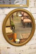 An Oval gilt framed mirror with beaded decoration. 58CM.
