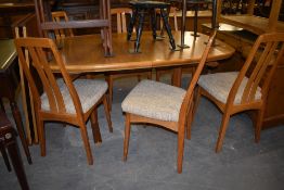 A modern Danish teak extending dining table, sold together with two additional leaves and six