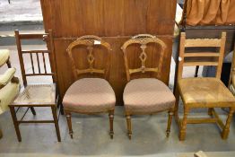A pair of late Victorian mahogany bedroom chairs, together with a 20th century oak leather seated