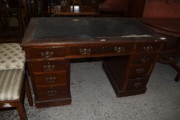 An Edwardian stained mahogany pedestal writing desk, of traditional form 72CM. X. 121CM. Damage to