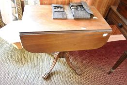 A 19th century pedestal Pembroke table of traditional form with double drawers to one end, opposed