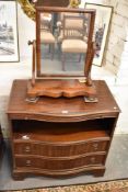 A reproduction serpentine mahogany media cabinet, sold together with a Victorian mahogany swing